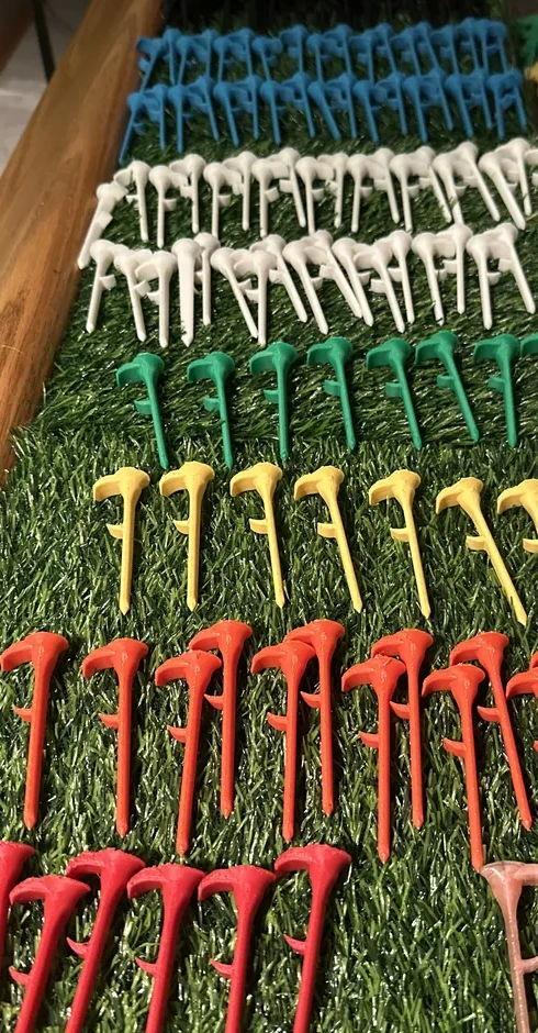 Actual Shotgun Start Tees arranged by color during small-batch product production